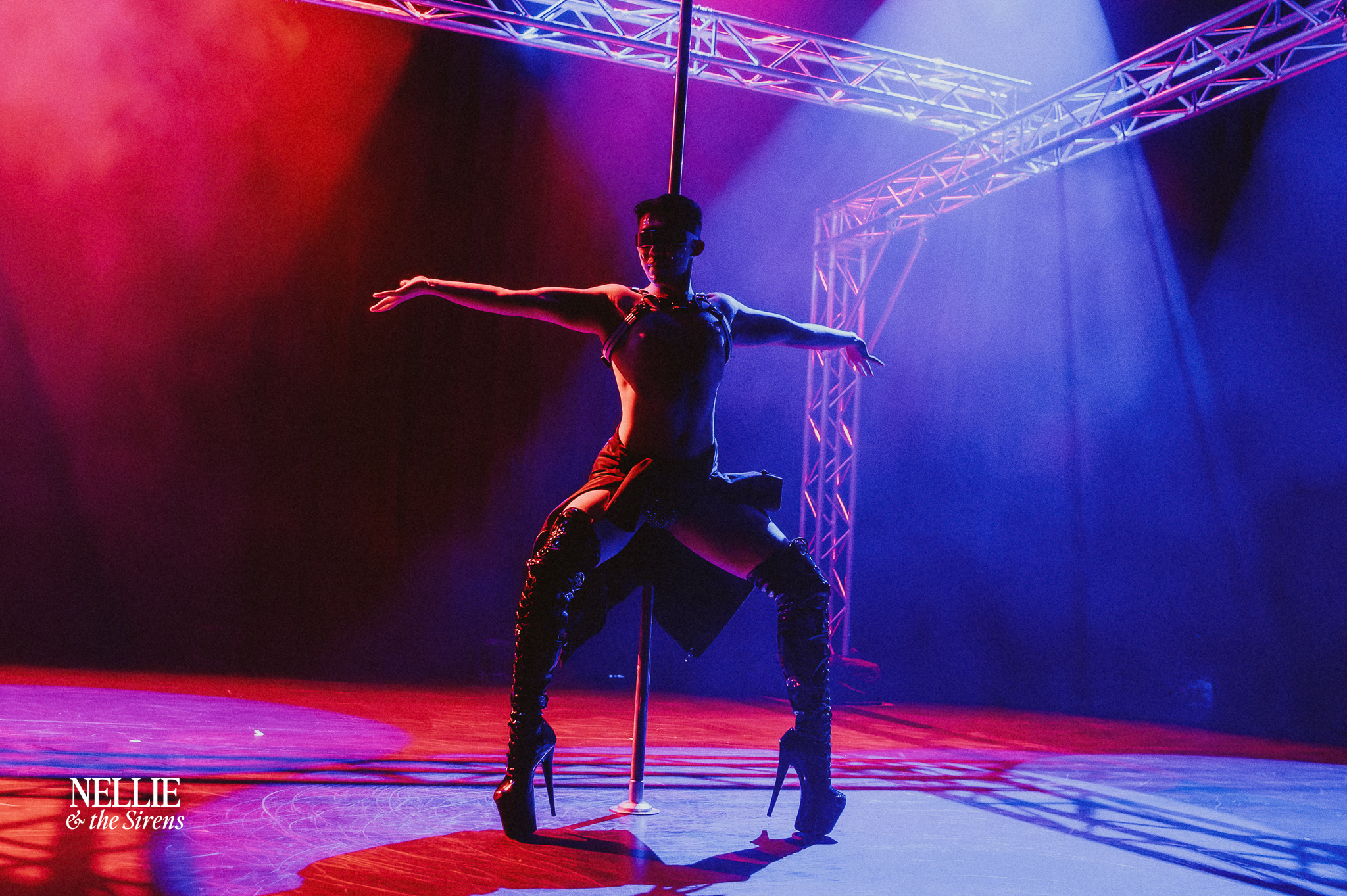 Lumin — on stage with pole, lit red and blue